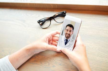 Woman speaking with her doctor using a cell phone.